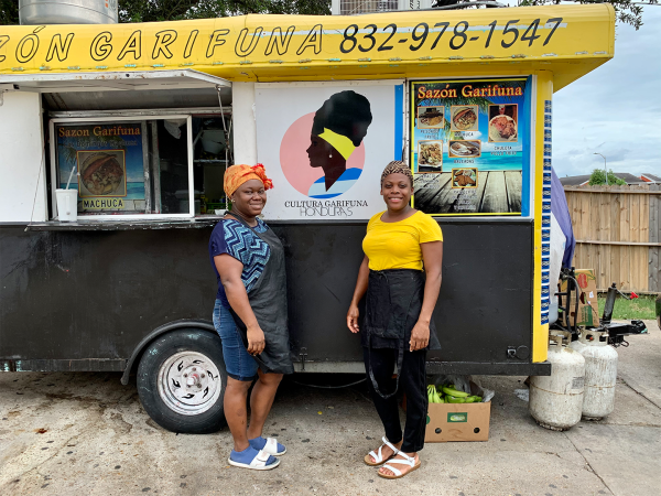 Color photo of two women in front of a Garifuna food truck.