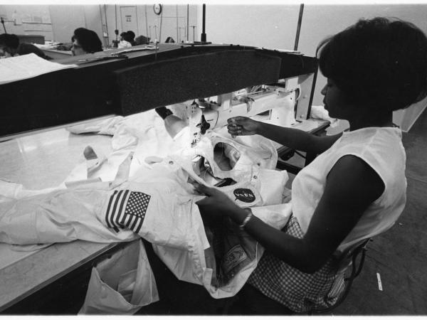Hazel Fellows, an African American woman, sews a spacesuit