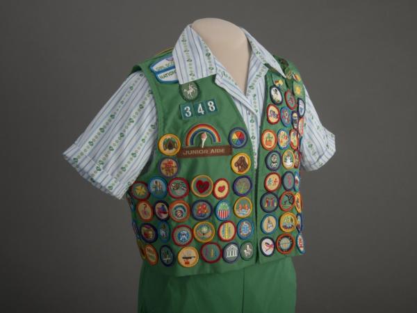Girl Scout vest covered in badges.