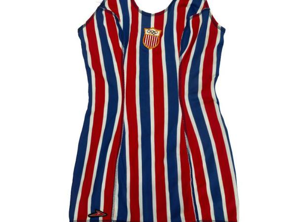 Red and blue vertically striped once piece swimsuit. Olympic logo on a patch in the center just under the neckline.