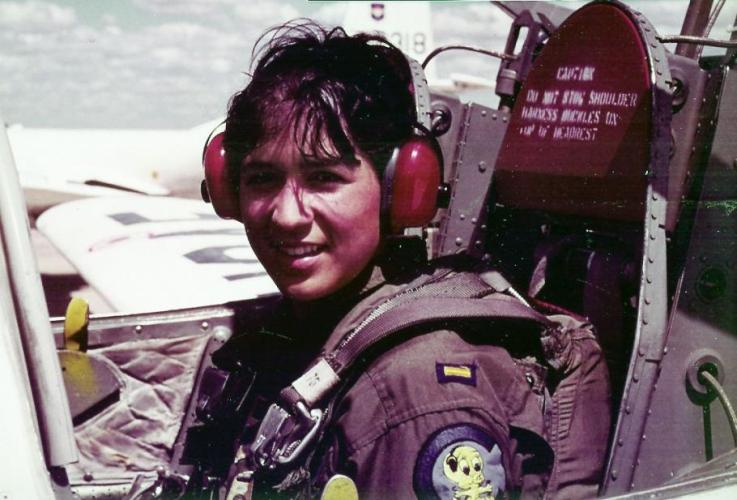 Lt. Col. Olga Custodio sits in the cockpit of a plane