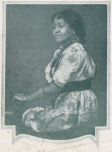 Black and white photo of Annie Malone seated in profile