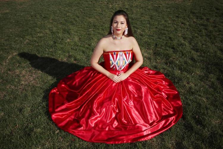 Isabella Aiukli Cornell wears her prom dress and beaded jewelry