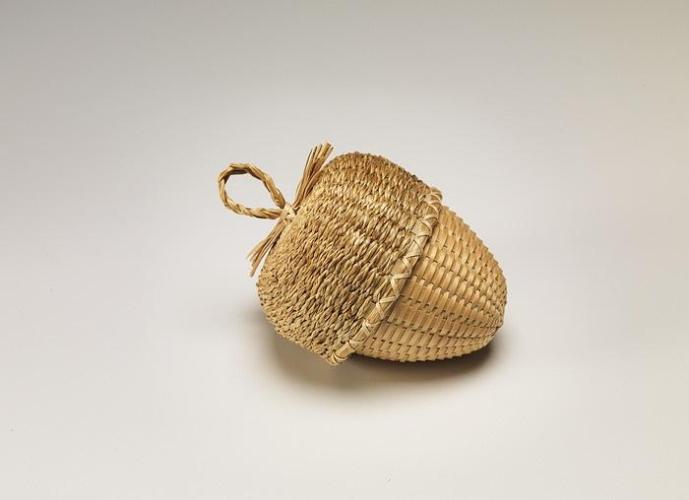 Wicker-plaited basket shaped like an acorn, where the acorn cap is a lid.