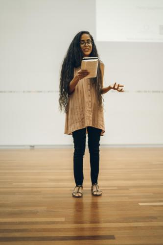 Photo of Kathy Jetñil-Kijiner reading her poetry