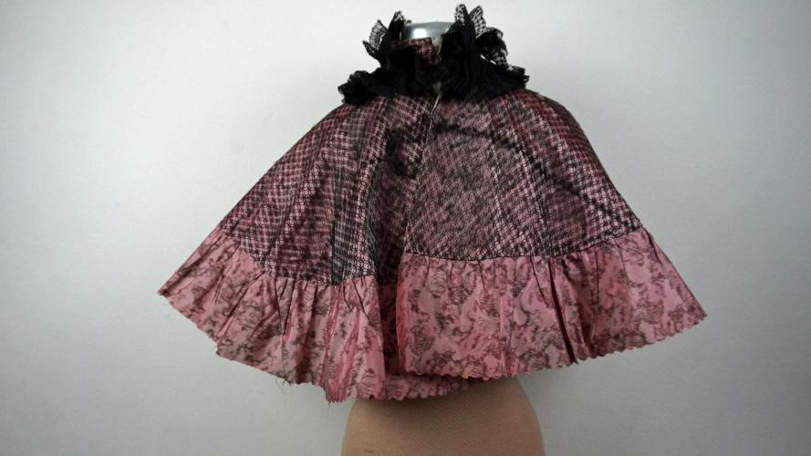 Capelet made of faded pink taffeta with black lace netting over top