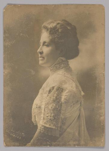 Mary Church Terrell in profile. She wears a dress with a high collar and fringed sleeves.