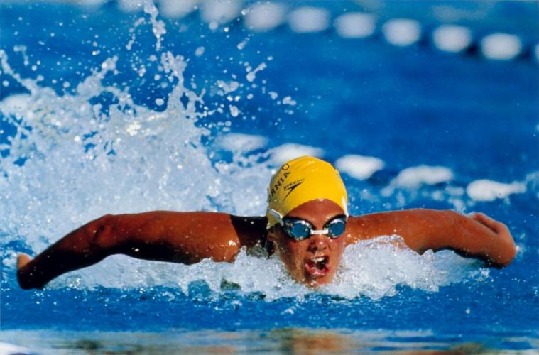 Torres breaks through the surface of the water as she races