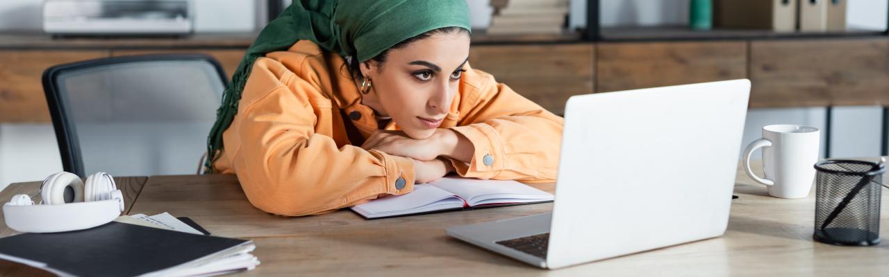 woman focused on online webinar while learning at home